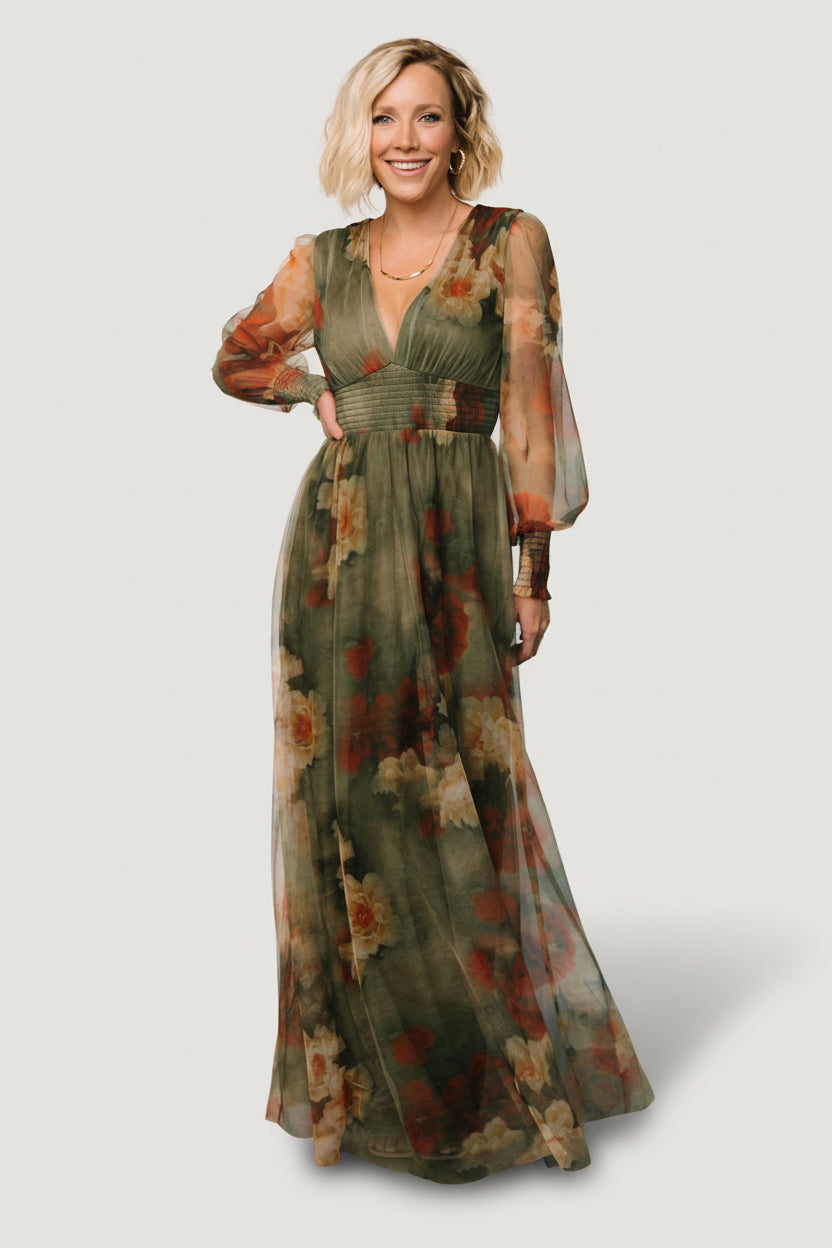 Model wearing Layla Tulle Maxi Dress in Olive + Rust floral print; long smocked sleeves, deep V-neck, smocked waist, flowing tulle skirt.