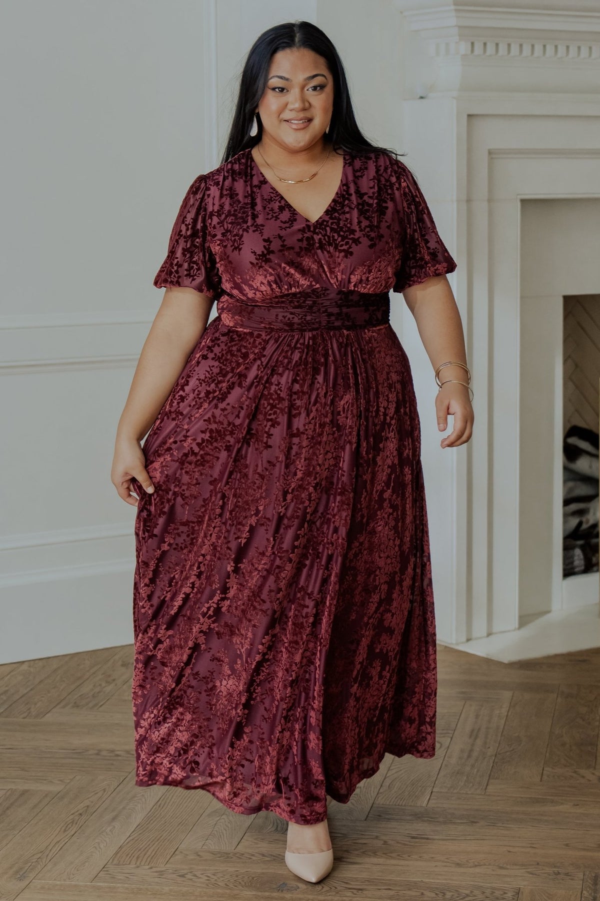 Detail shot of the gathered waist and seam construction on the Mulberry embossed velvet maxi dress for a tailored fit.