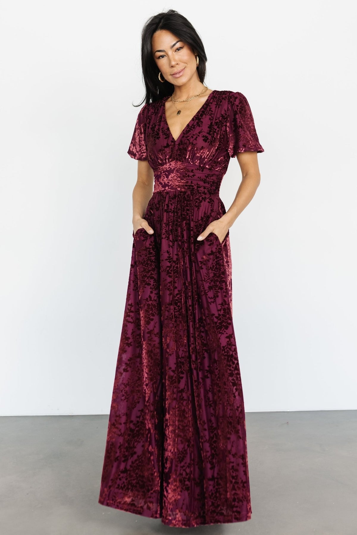 Side profile of the Mulberry maxi dress showing gathered waist detail, skirt drape and convenient side pockets.