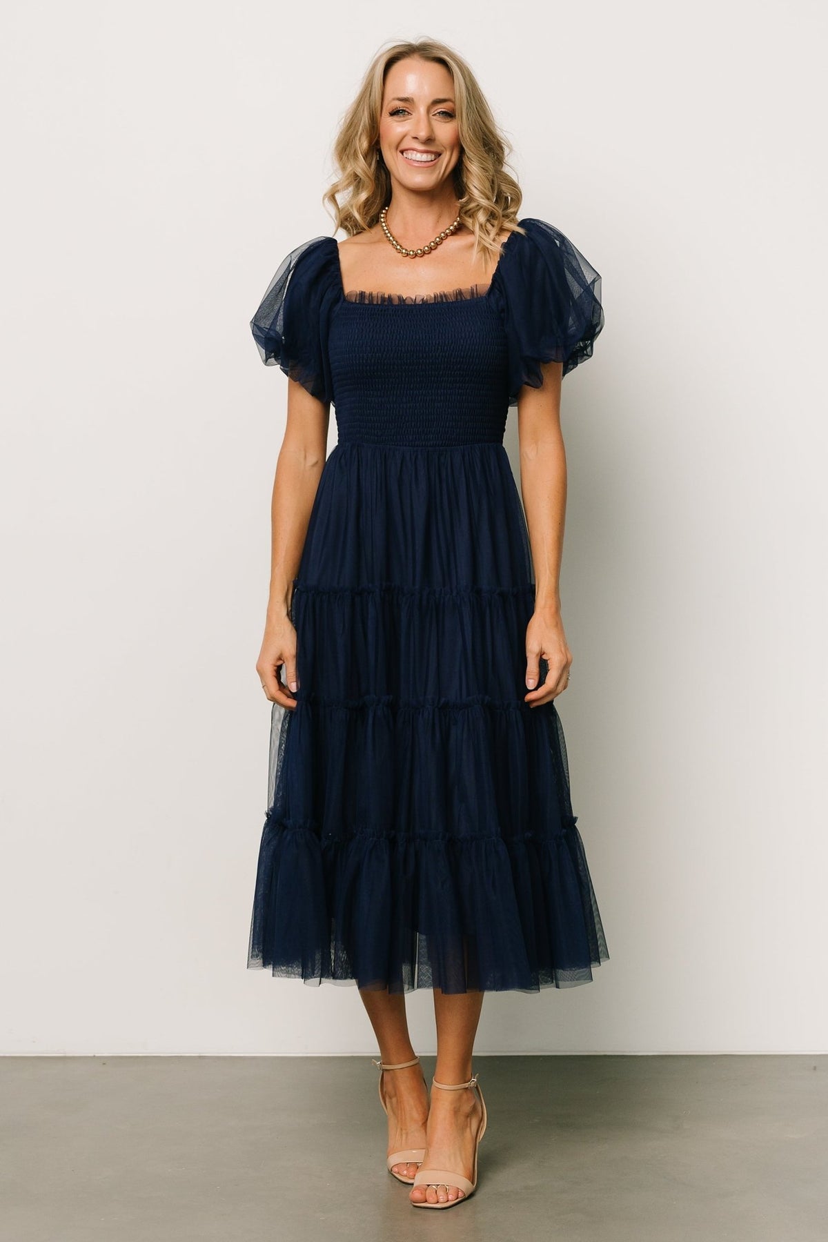 Fabric and skirt detail of the navy Liv tulle midi dress, showing the layered tulle overlay and the fully lined interior construction.