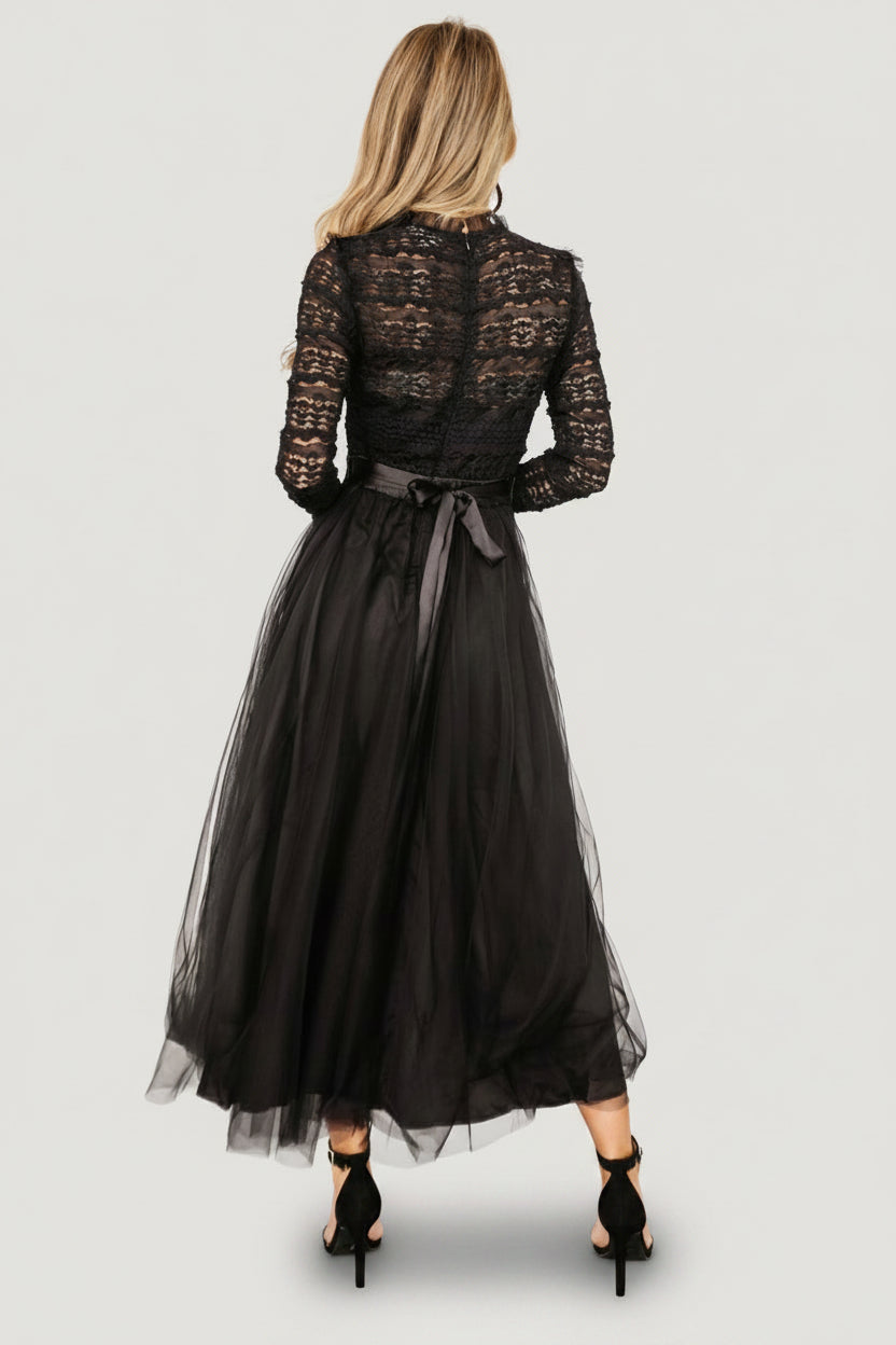 Back view of the Lonnie Tulle Dress in black showing the hidden zipper at the bodice, satin waist tie and tiered tulle skirt for added volume.