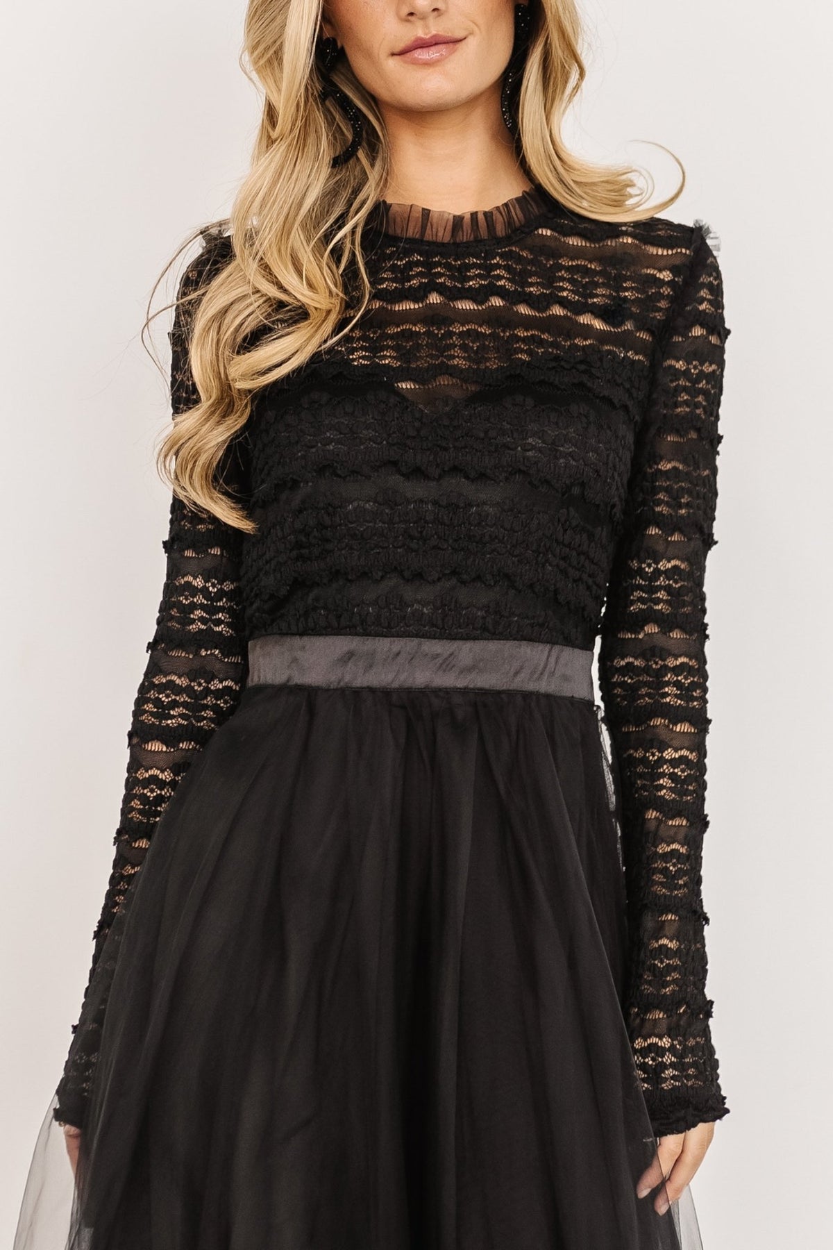 Detail shot of the satin waist tie, elasticated waist and layered tulle fabric of the Lonnie Tulle Dress in black, emphasizing texture and finish.