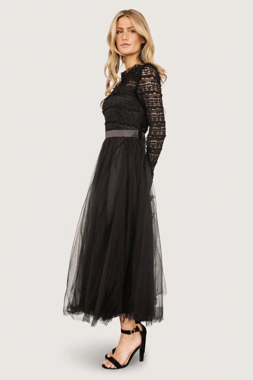 Studio image of the Lonnie Tulle Dress in black on a mannequin, showing overall silhouette with ruffled lace overlay and midi tulle skirt movement.