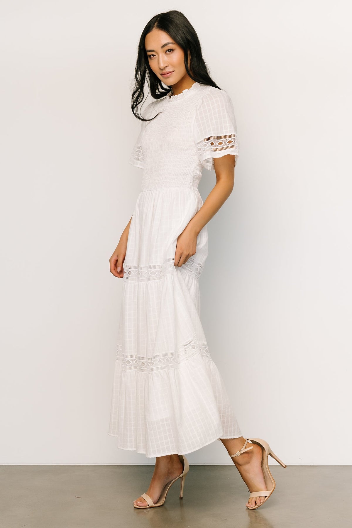 Back view showing keyhole-and-button closure and smocked bodice on Loveland Geo Lace Maxi Dress in off-white.