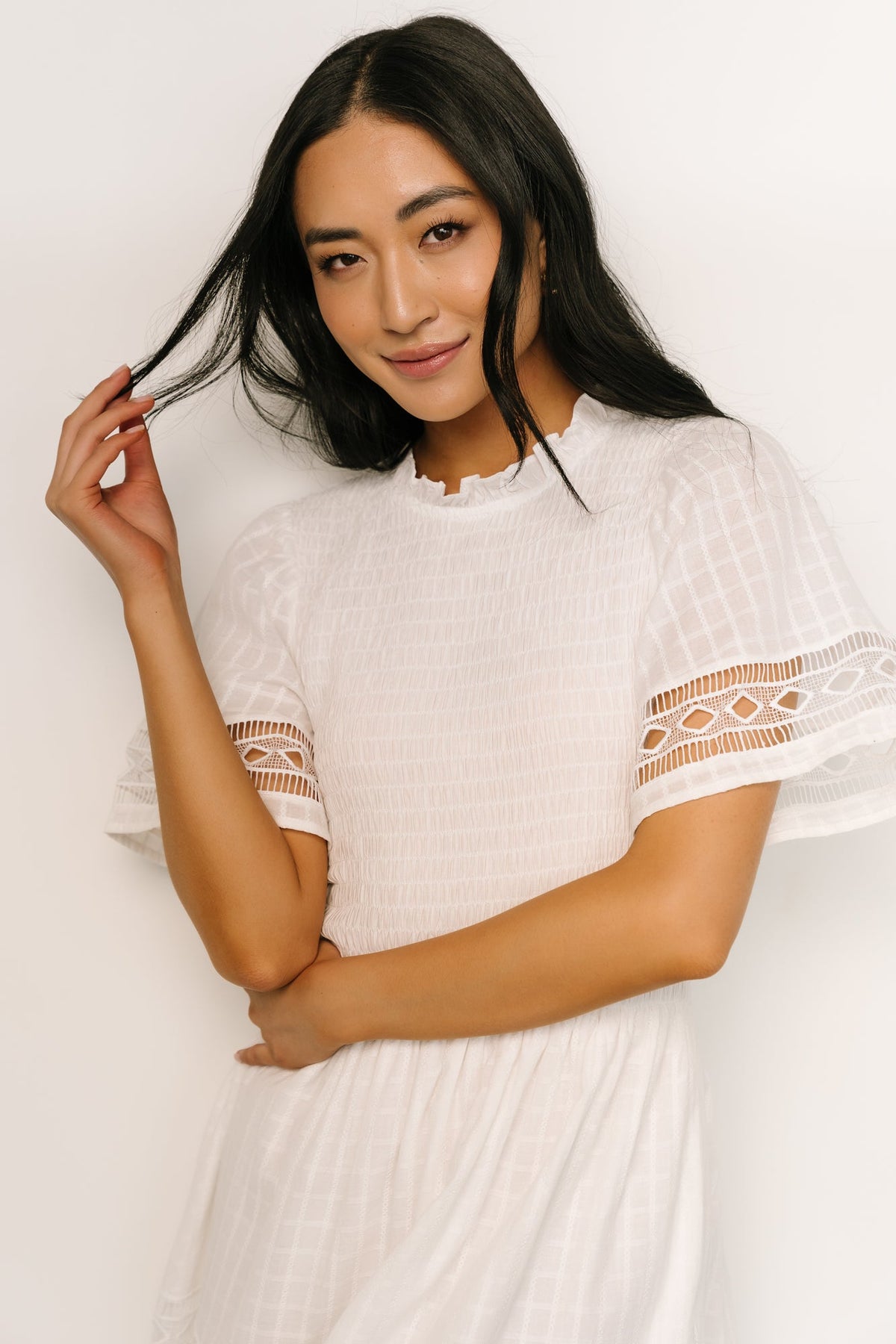 Close-up of geo lace texture and ruffle detail on off-white Loveland Maxi Dress showing intricate embroidery.