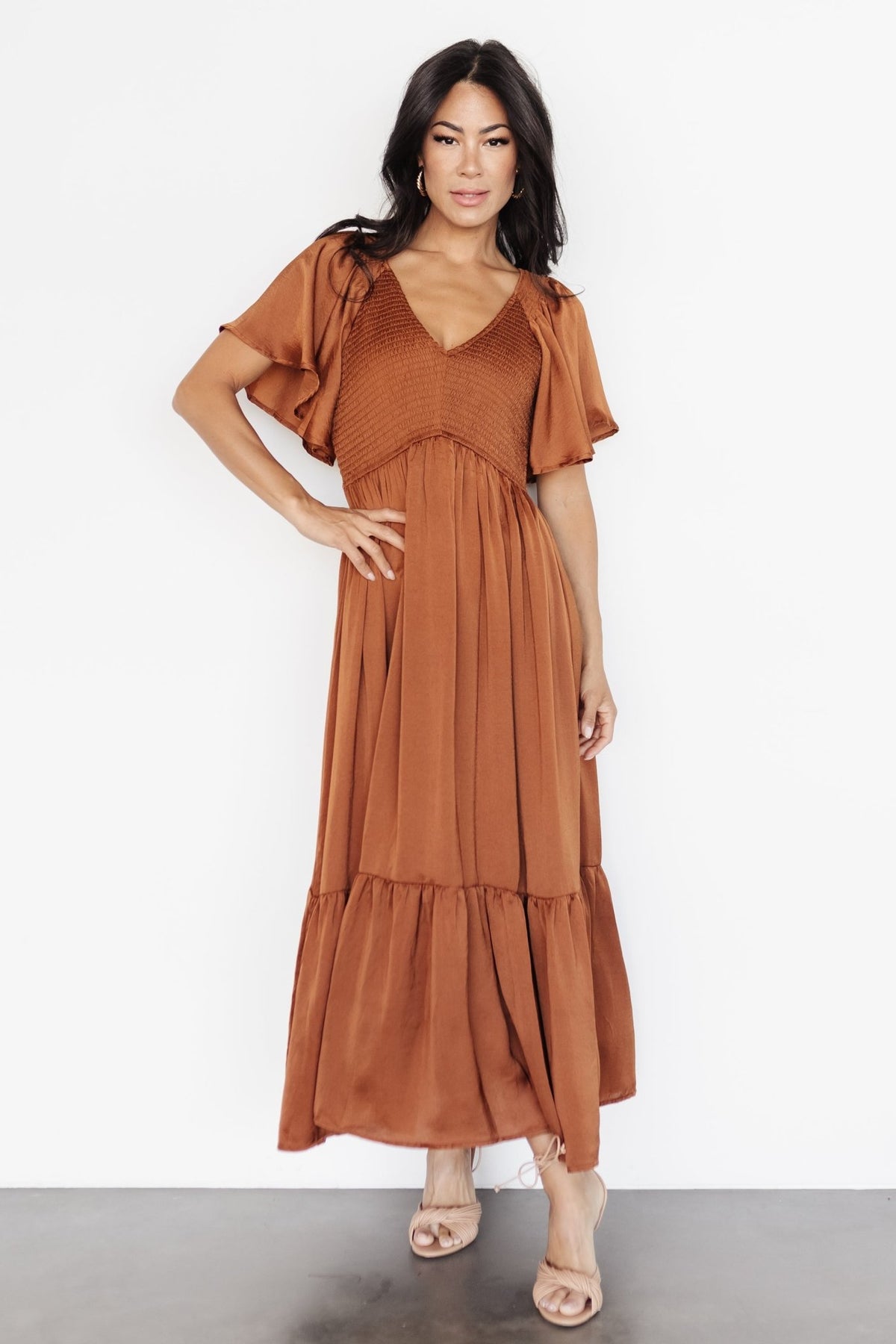 Back view of the dark copper midi dress showing rear skirt drape, hemline, and neckline shape from the back.