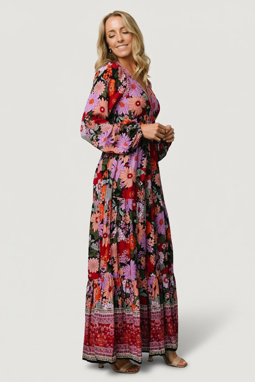 Back view of Malena Maxi Dress in Black Multi on model, showing full-length silhouette, tiered hem and print placement.