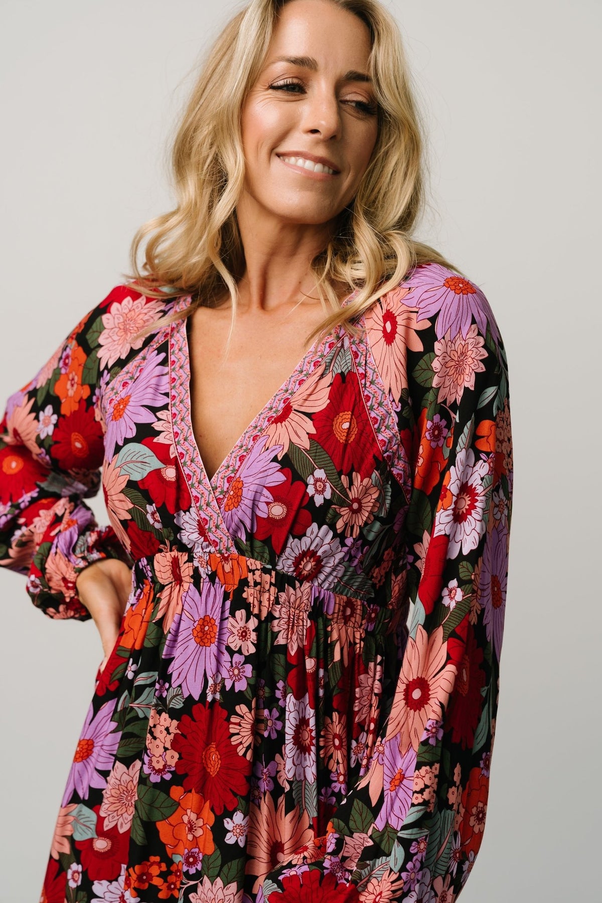 Side view of Malena Tiered Maxi Dress in Black Multi, emphasizing the left-side slit, tiered skirt and natural drape of rayon fabric.