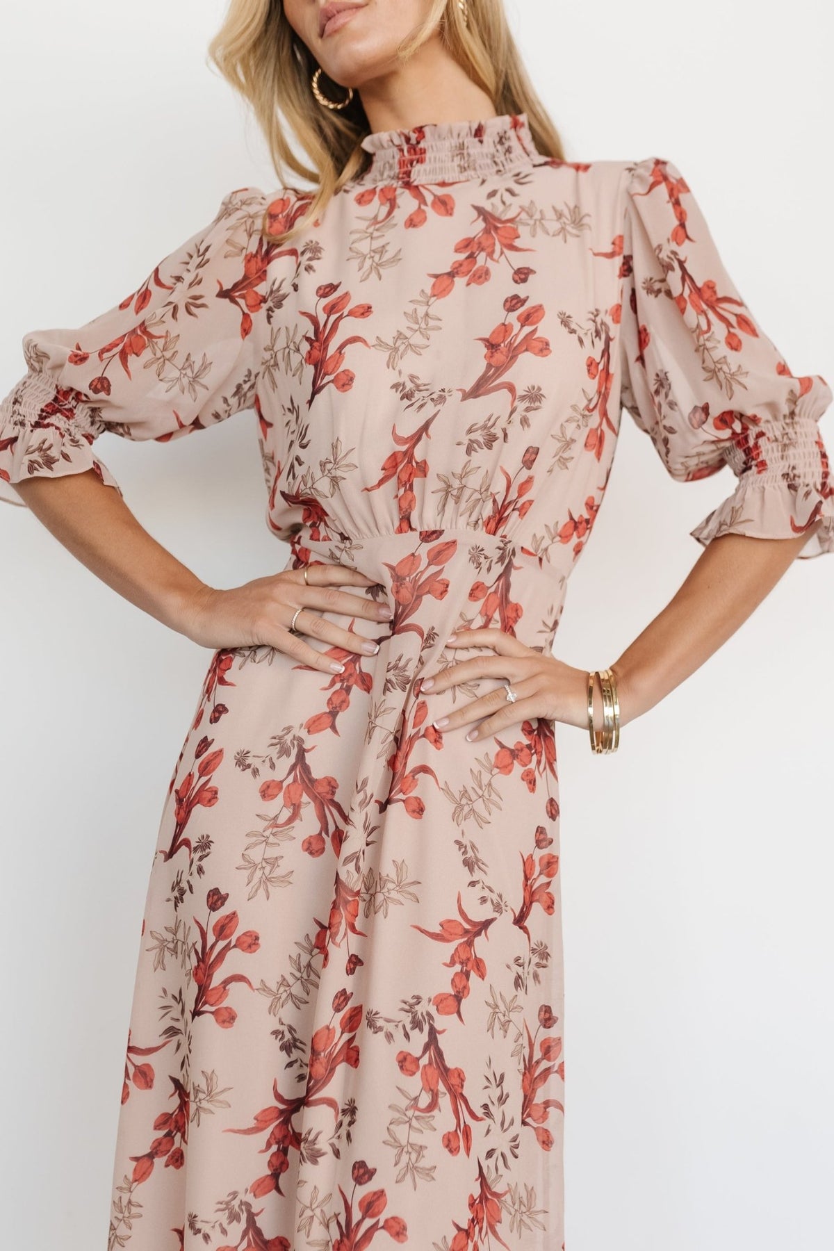 Back view of blush floral maxi dress showing keyhole back with double-button closure and elastic back waist shaping on model.