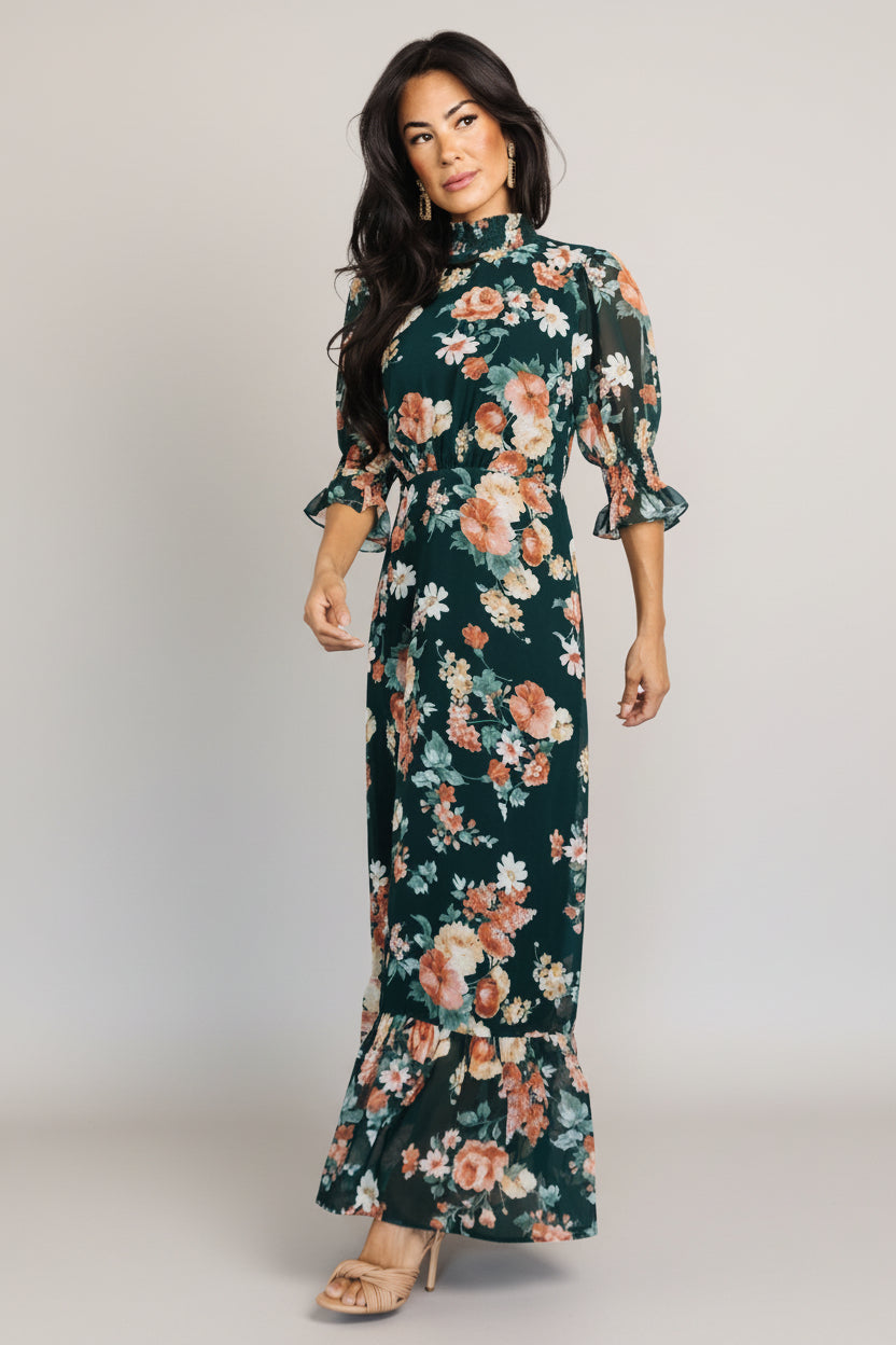 Close-up of pleated front waist and lined bodice on the Marie mock neck maxi dress in dark green floral chiffon.