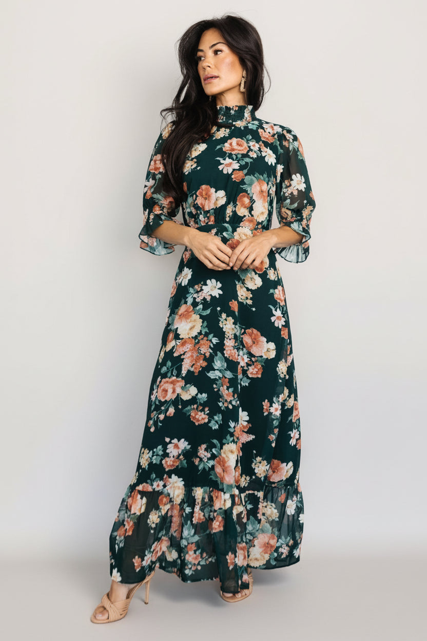 Front view of Marie mock neck maxi dress in dark green floral chiffon with smocked neckline, ruffle cuffs, and tiered maxi skirt.