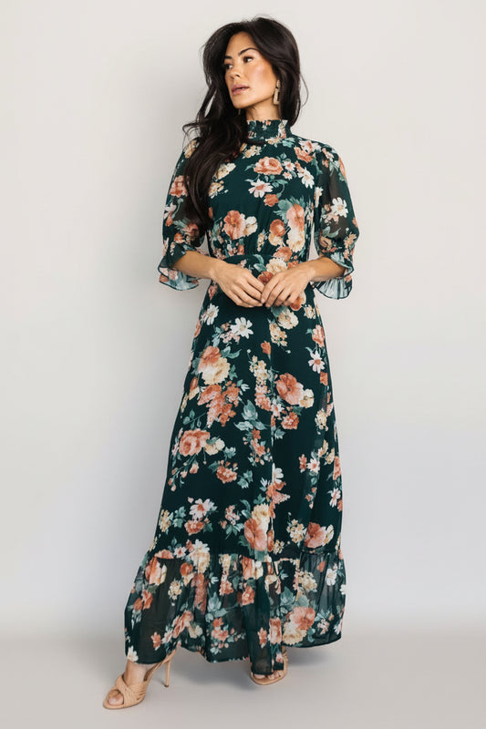 Front view of Marie mock neck maxi dress in dark green floral chiffon with smocked neckline, ruffle cuffs, and tiered maxi skirt.