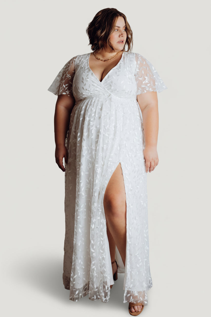 Detail shot of the elasticized waistband and removable waist tie on the Marseille embossed maxi dress in white, showing construction and texture.