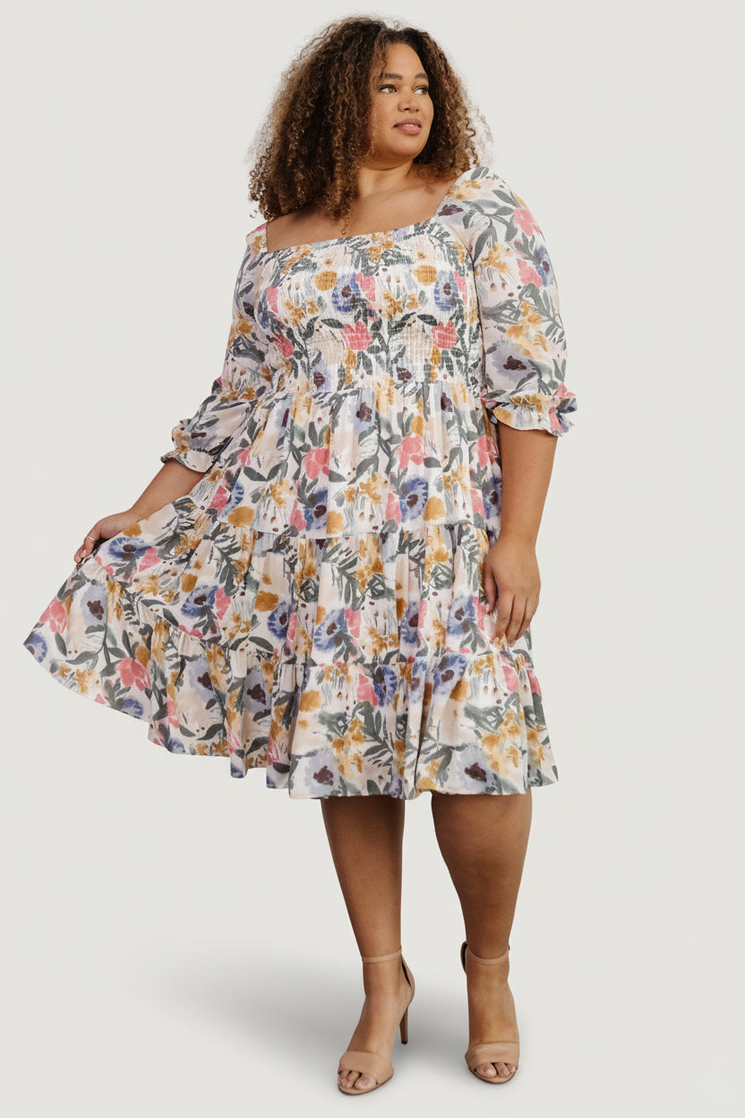 Close-up of the fully smocked bodice and square neckline of the multi floral midi dress, showing elastic shoulder detail and texture.