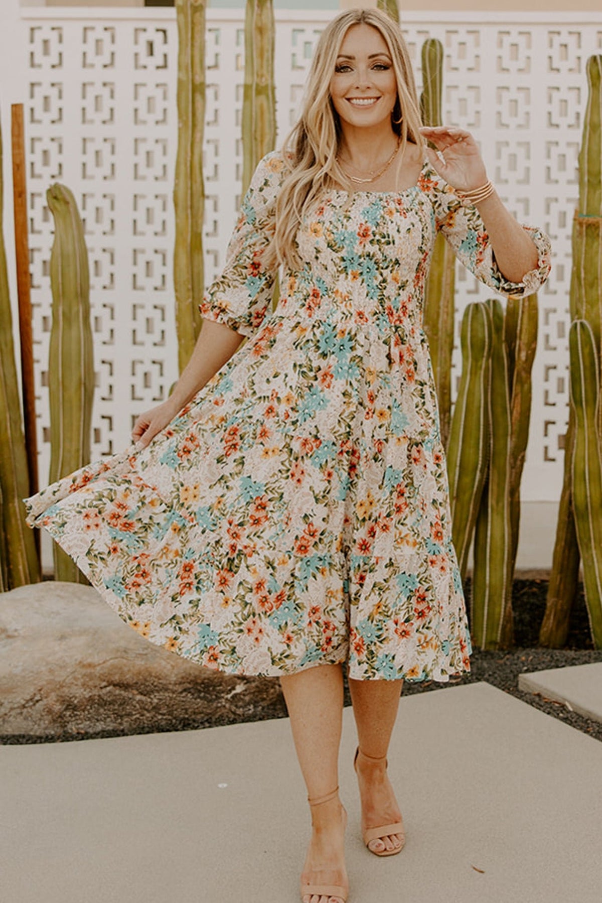 Styled outfit image showing the smocked midi dress with accessories, highlighting versatility from daytime to event wear