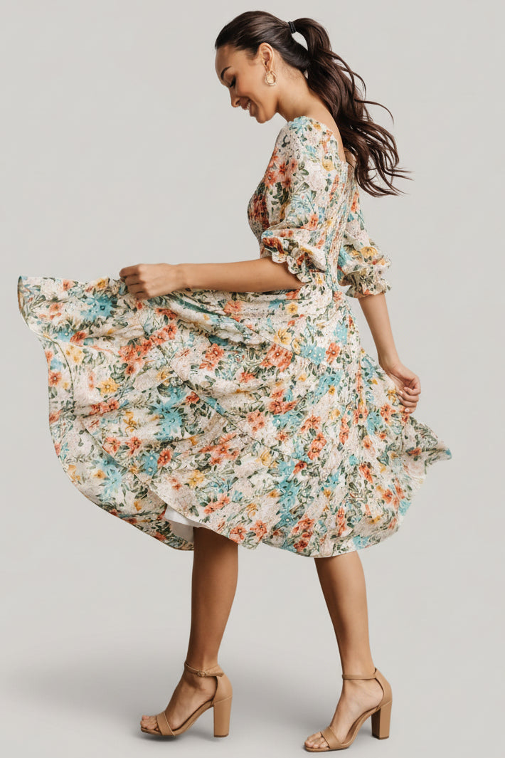 Side view highlighting the flowing tiered skirt and natural drape of the 100% polyester fabric in a multi floral pattern