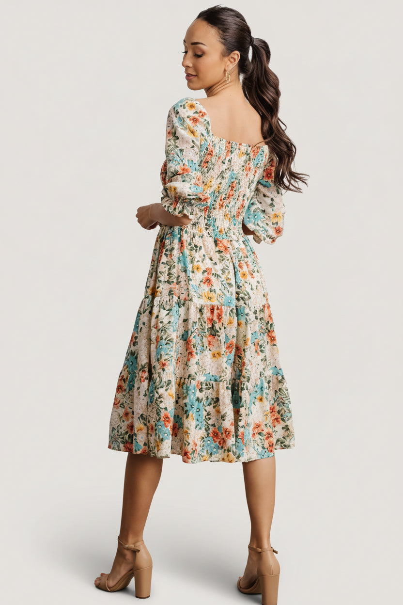 Model wearing the smocked midi dress styled with casual footwear, showing sleeve length, neckline and tiered skirt proportions