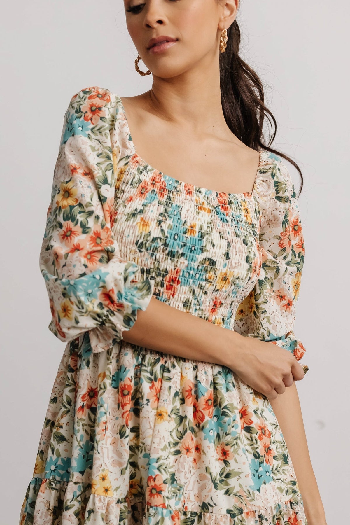 Full-length image of the tiered midi silhouette on model, showing overall length and relaxed movement of the dress