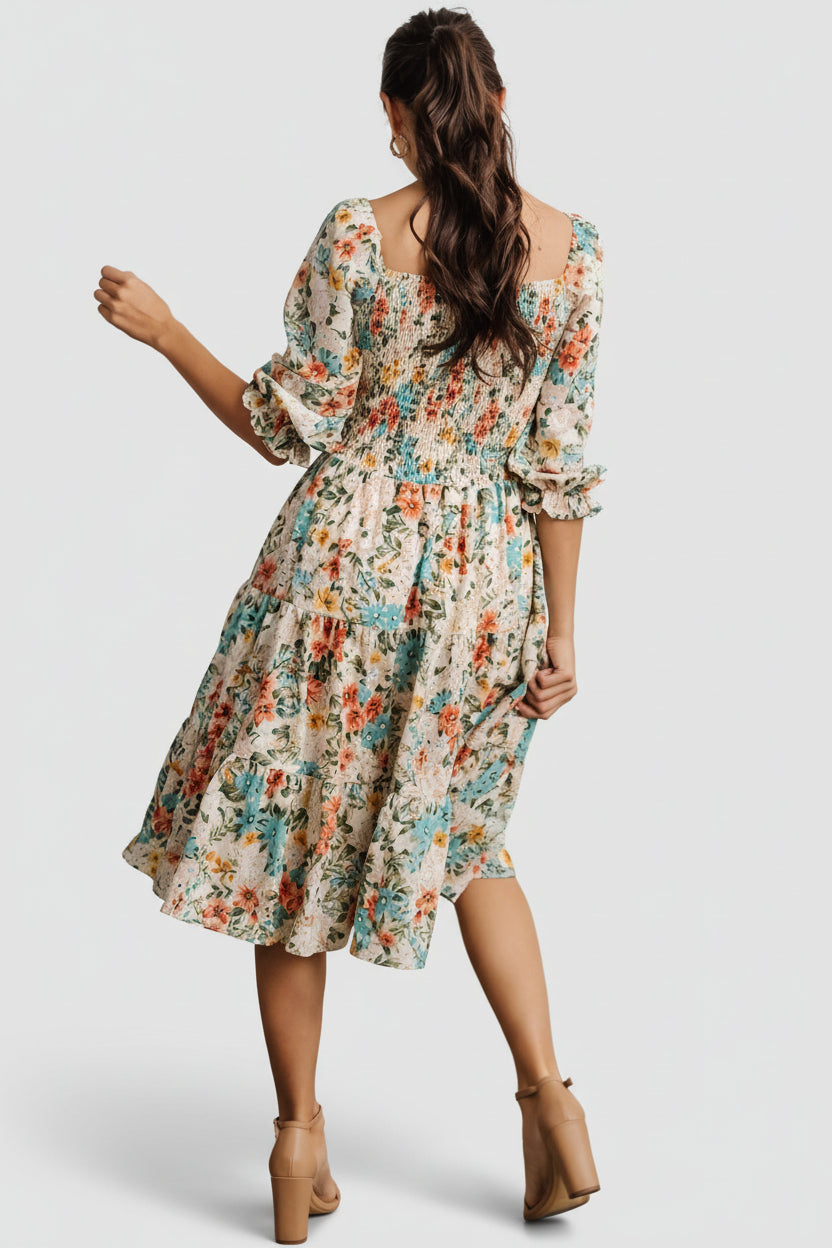 Close-up of fabric print and texture with smocking and stitching detail visible, emphasizing color and pattern scale