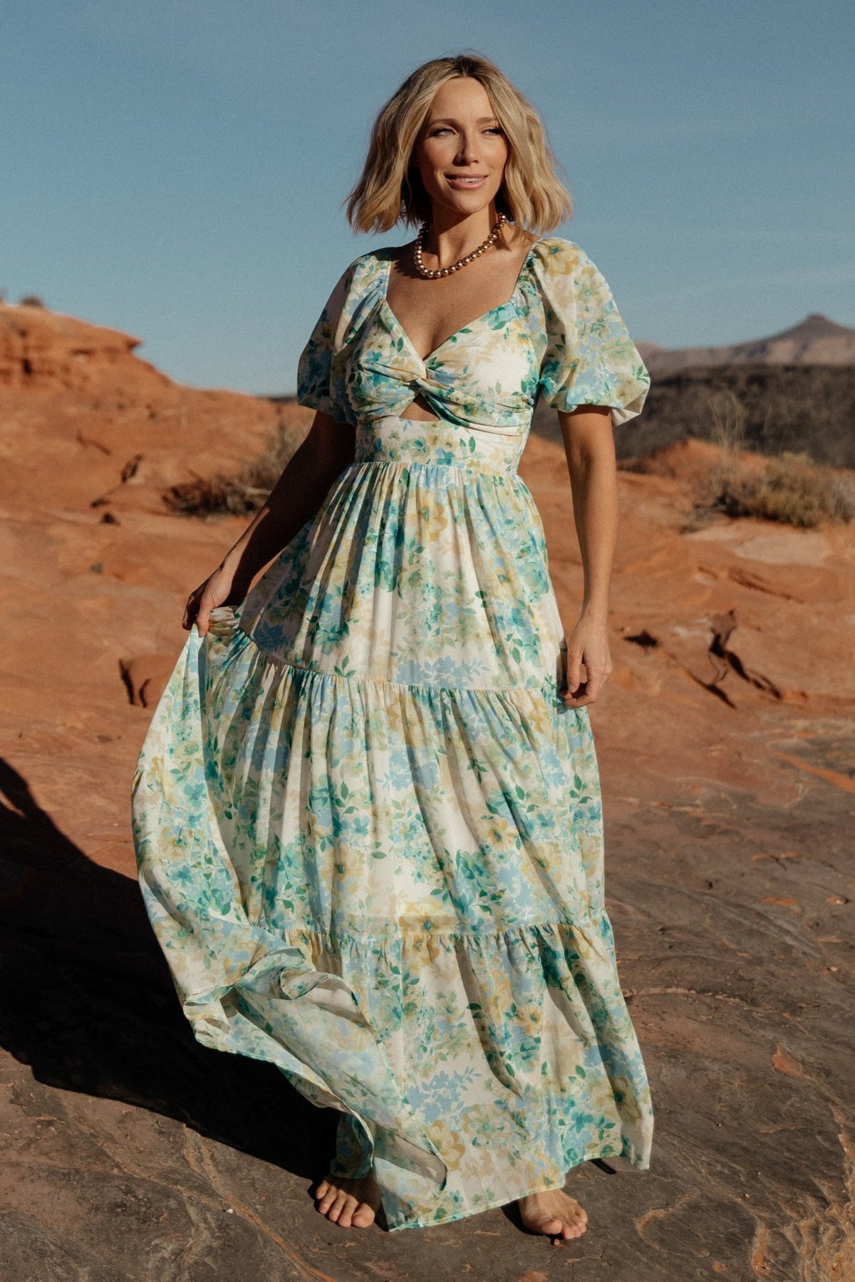 Back view of Maya Maxi Dress showing smocked back panel and elastic back waist for a flexible, comfortable fit in Garden Multi print.