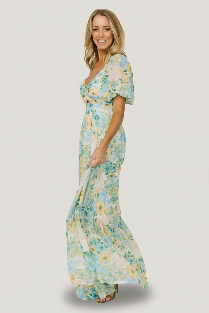 Full-length shot of model twirling in the Maya Maxi Dress, illustrating tiered maxi skirt movement and vibrant garden multi floral pattern.