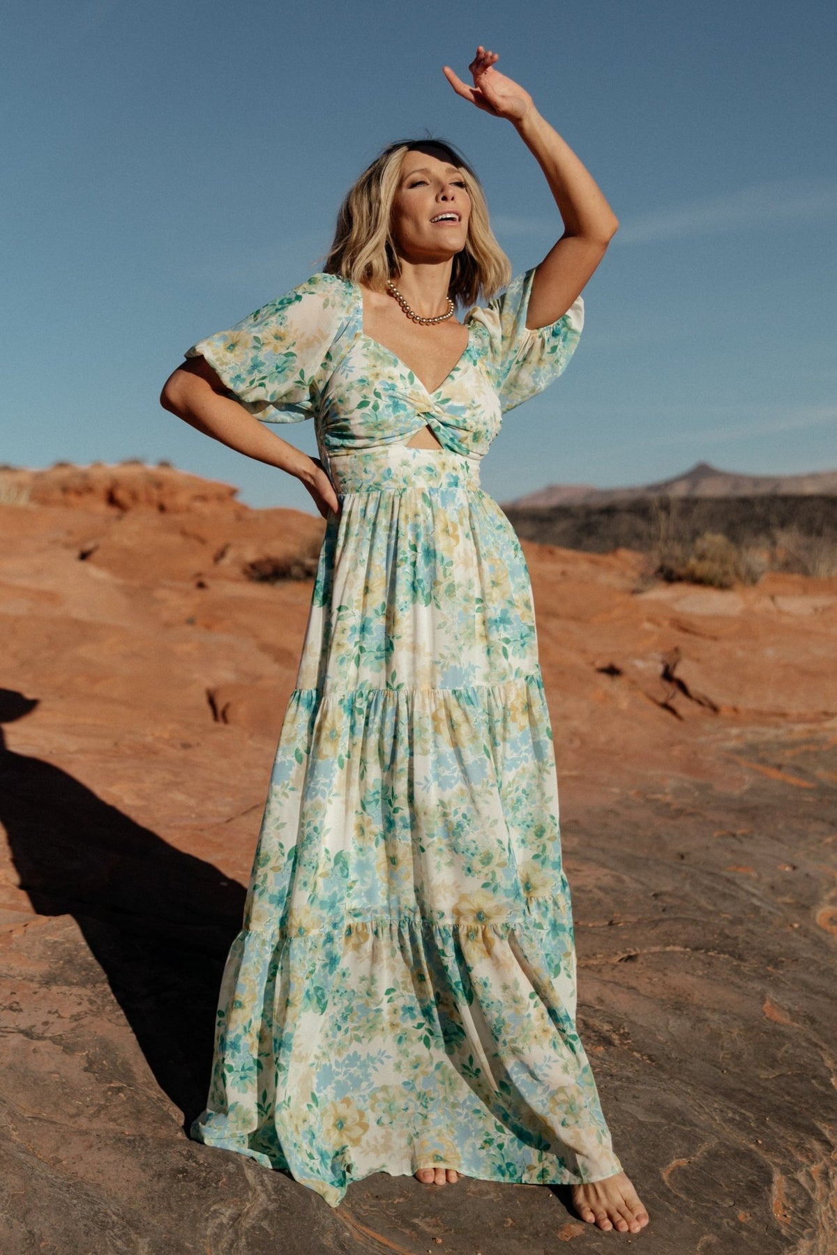 Styled look of Maya Maxi Dress paired with simple sandals, showing how the floral print and sweetheart neckline work for daytime events.