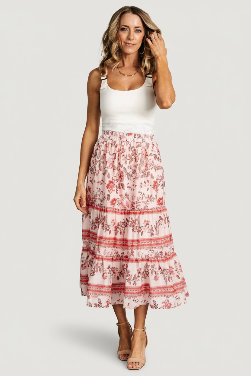 Full-length photo of Meg skirt in blush multi floral pattern styled with a tucked top, highlighting midi length and tiered ruffle silhouette on model.