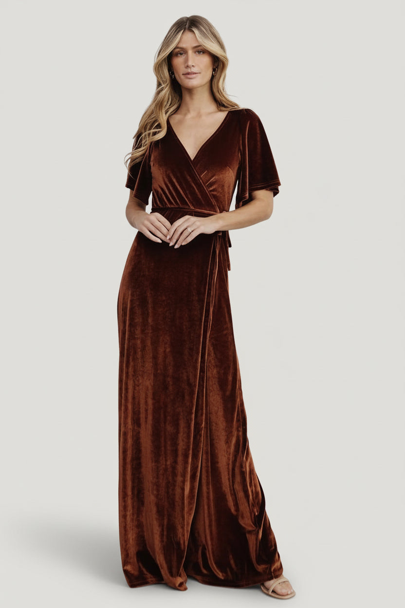 Full-length view of Meghan velvet wrap maxi in bronze on model, showing length, tulip hem and overall elegant silhouette for formal wear.