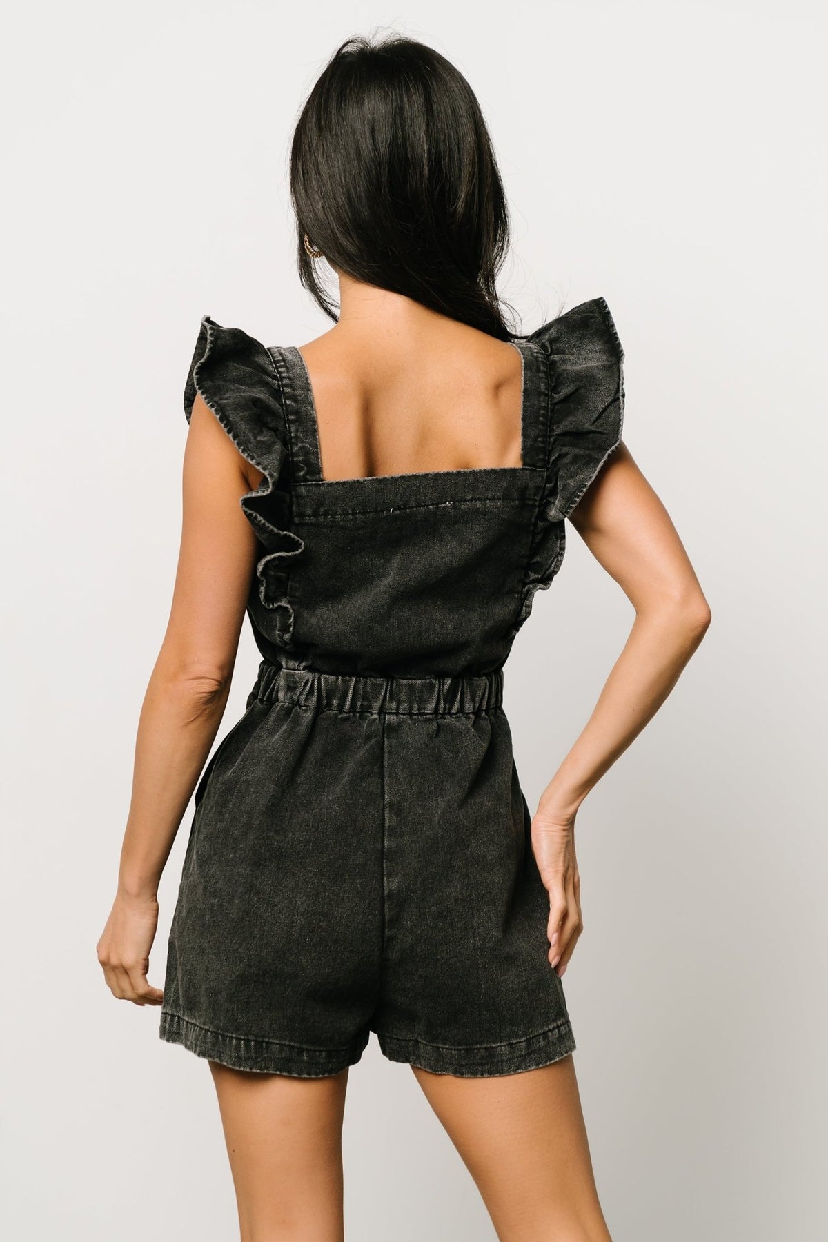 Back view of the romper displaying the elasticized waistline and how the shorts sit for a relaxed, flattering fit.