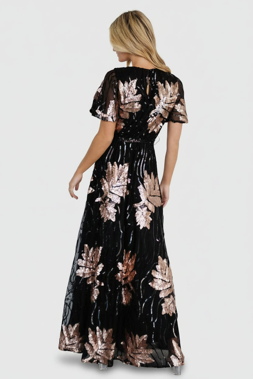 Back view showing keyhole and button closure with waist sash tied, revealing lined body and sheer sequin-adorned sleeves.