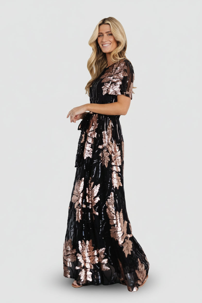 Detailed shot of short sheer sleeve and round neckline with dense sequin coverage and comfortable lining visible beneath.