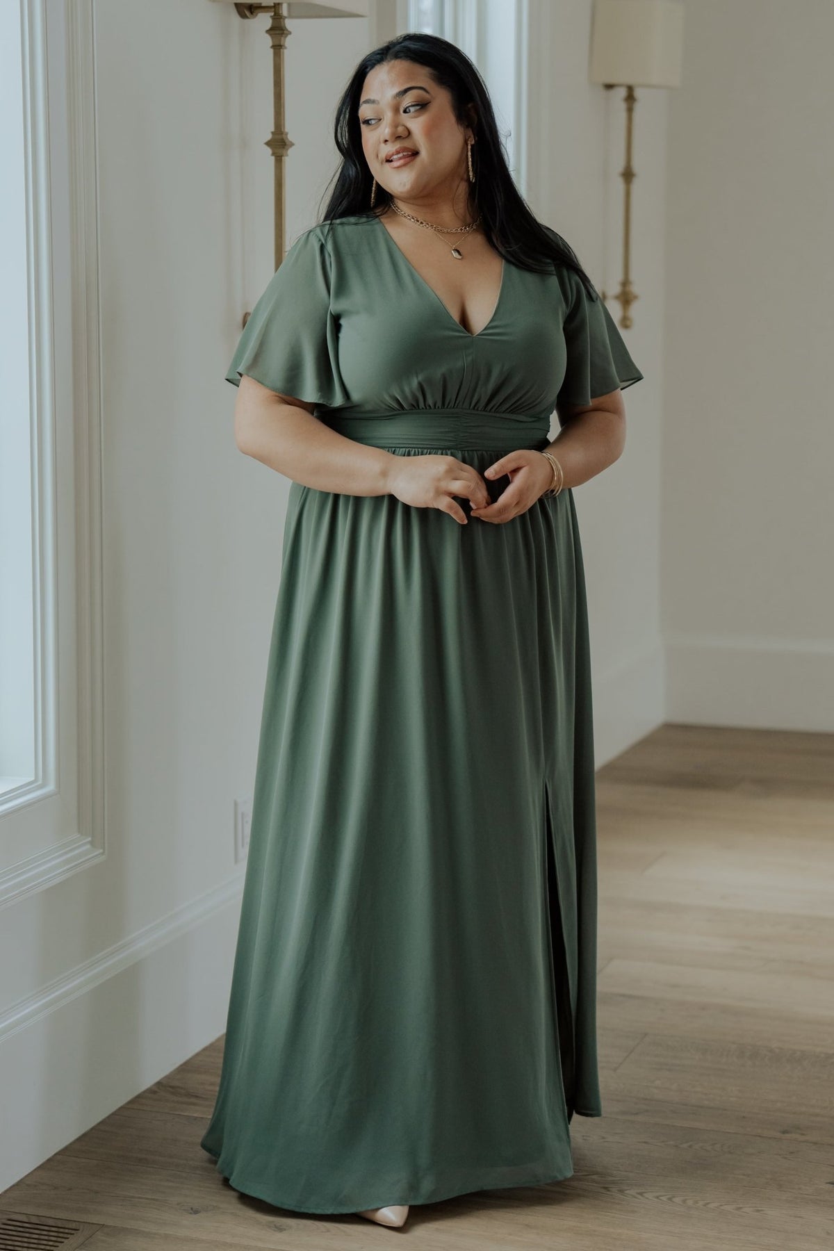 Back view highlighting the smocked back waist of the Ramona Maxi Dress in dark sage with fully lined body and unlined sleeves.