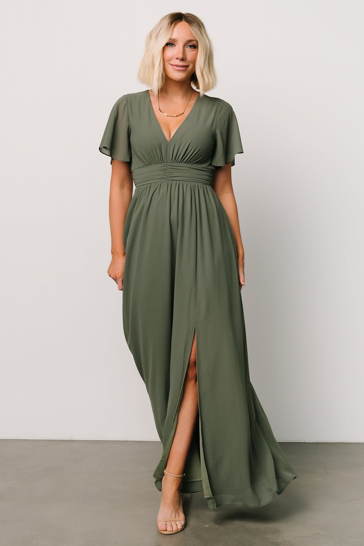Styled outfit of Ramona Maxi Dress in dark sage paired with simple accessories, showing versatile wear for weddings or events.