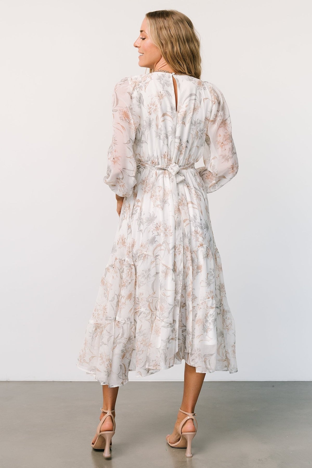 Styled flat-lay and accessory pairing for the Raven off-white floral midi dress, showing texture of chiffon and lining length.