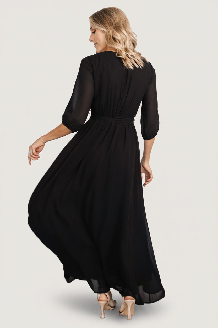 Back view of Rebecca Maxi Dress in black displaying the keyhole back with button closure and elasticized back waistband for a tailored fit.