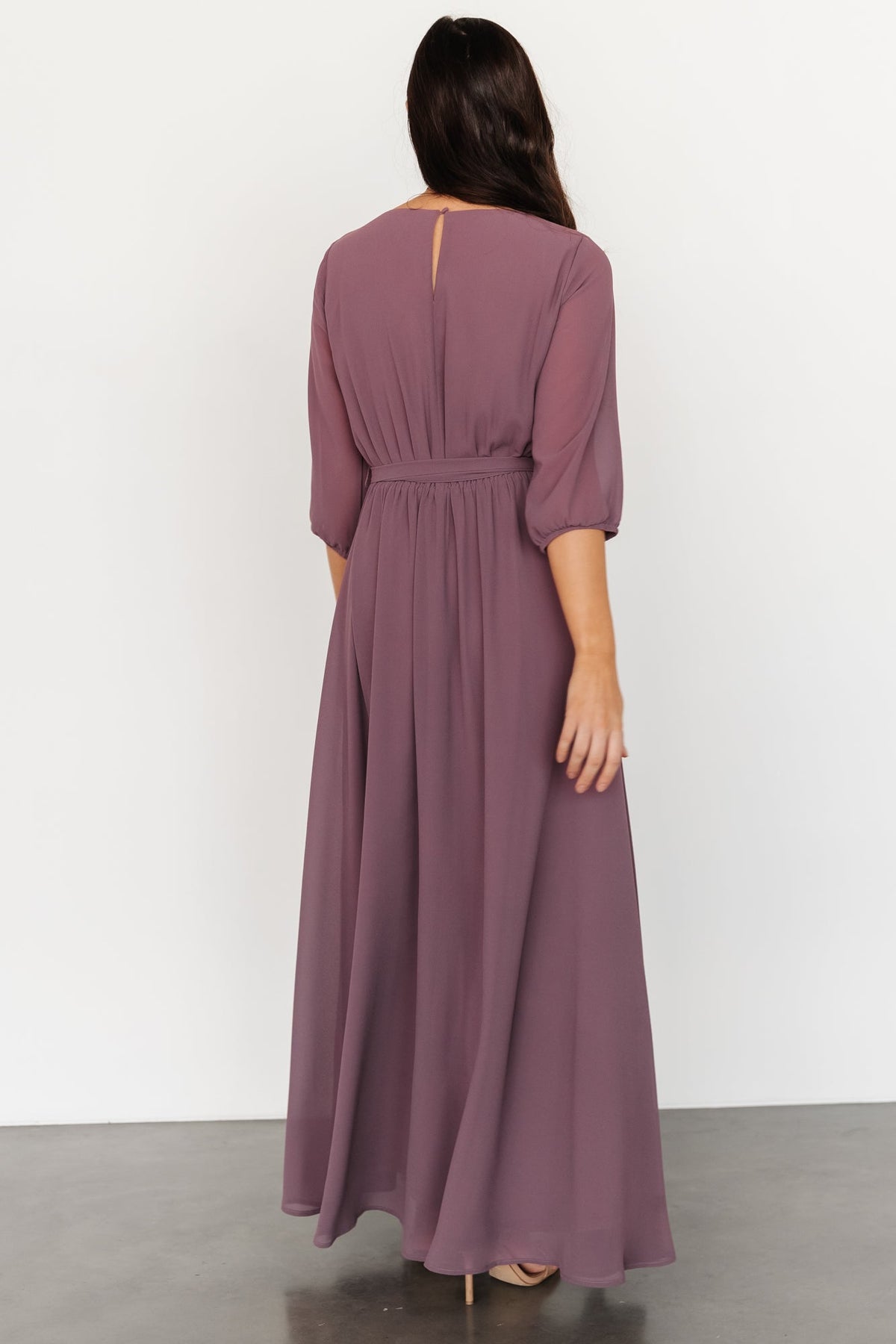 Back view of Rebecca Maxi Dress showing keyhole button closure, elastic back waistband, and belt tie.