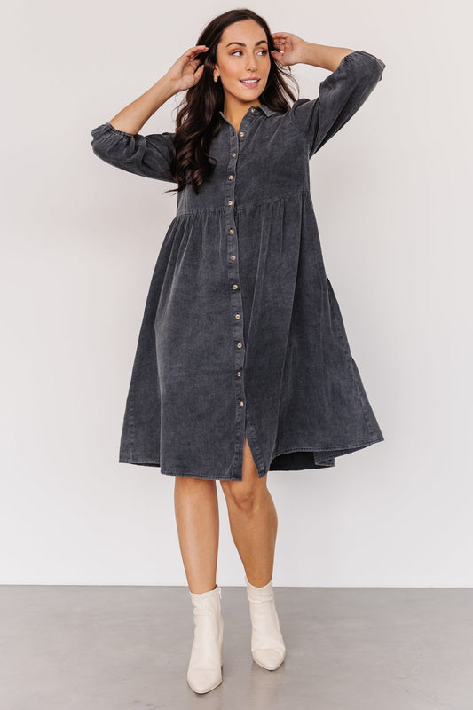 Front view of washed black Sari Babydoll Dress on model, showing button-front, gathered tiers, side pockets, and oversized 3/4 sleeves.