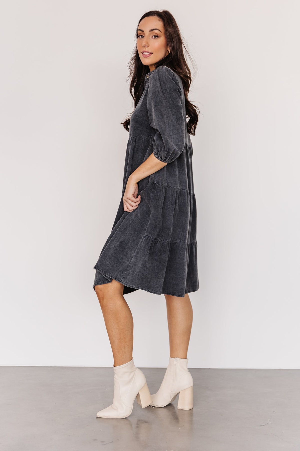 Back and side view of washed black Sari Babydoll Dress showing tiered back bodice, sleeve gather, and relaxed silhouette for easy movement.