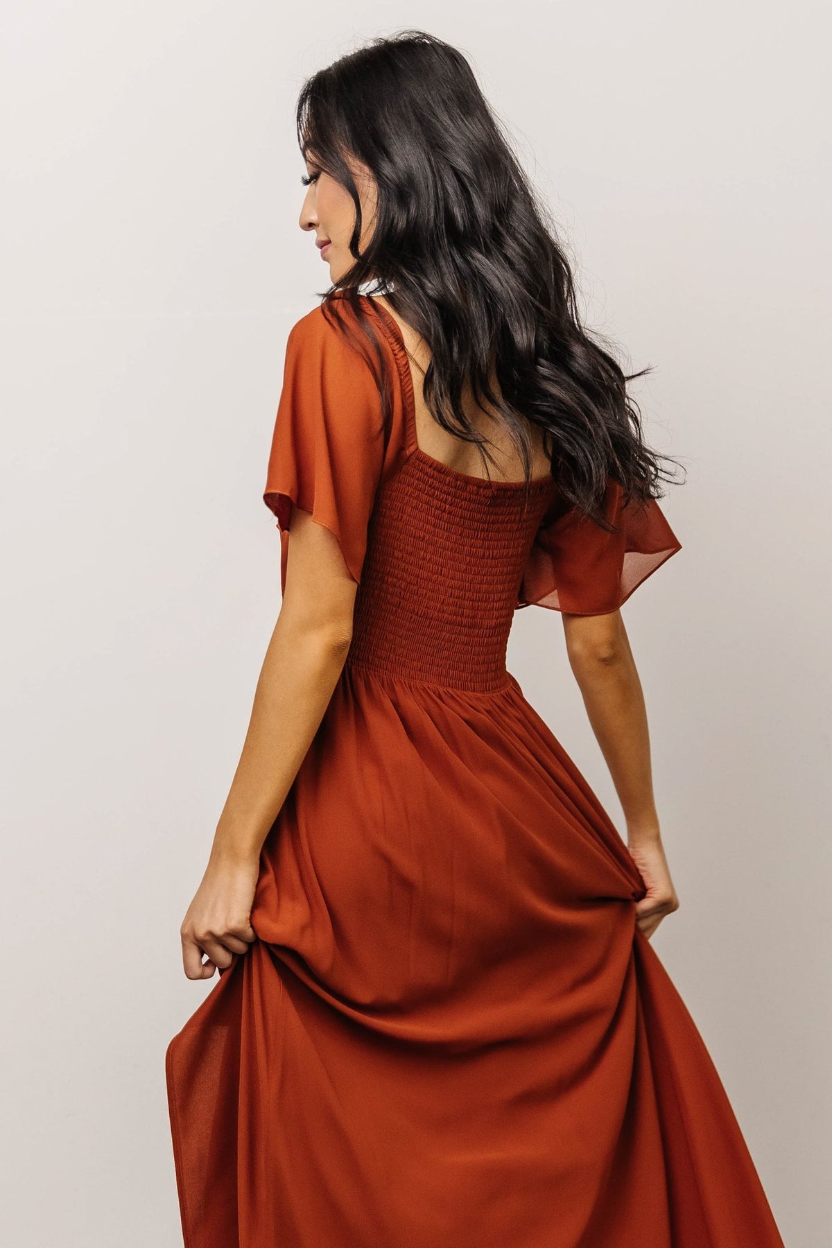 Close-up of sweetheart neckline and smocked back detail on Spice chiffon maxi dress, highlighting fabric texture and stitching