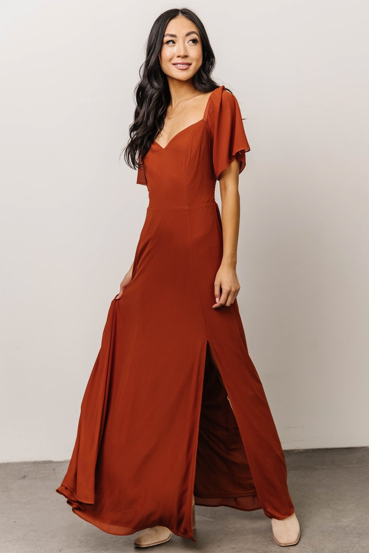 Three-quarter view of Spice maxi dress showing short sleeve silhouette, lined bodice and flowing chiffon skirt for occasion wear