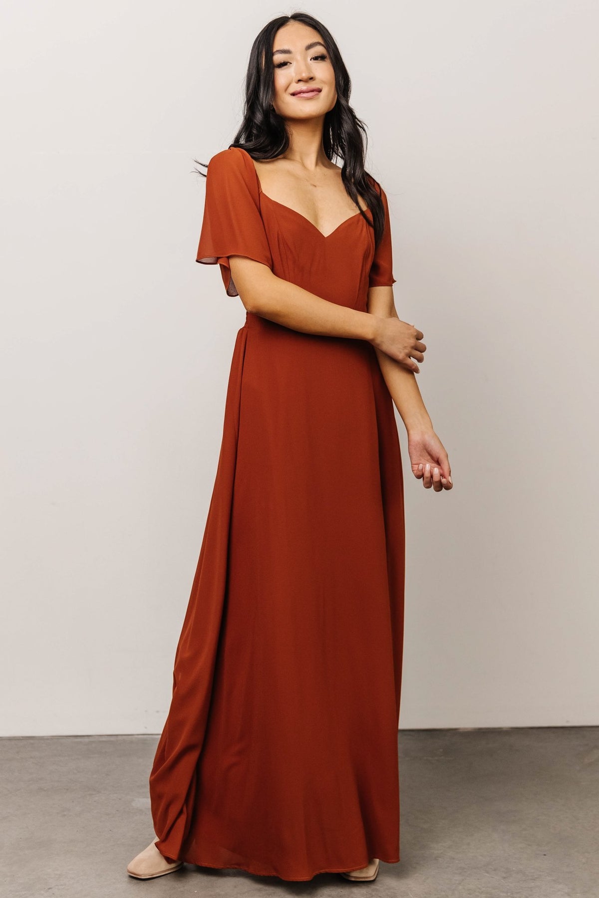 Full-length image of Spice chiffon maxi dress styled with heels, highlighting silhouette, hemline and occasion-ready design details
