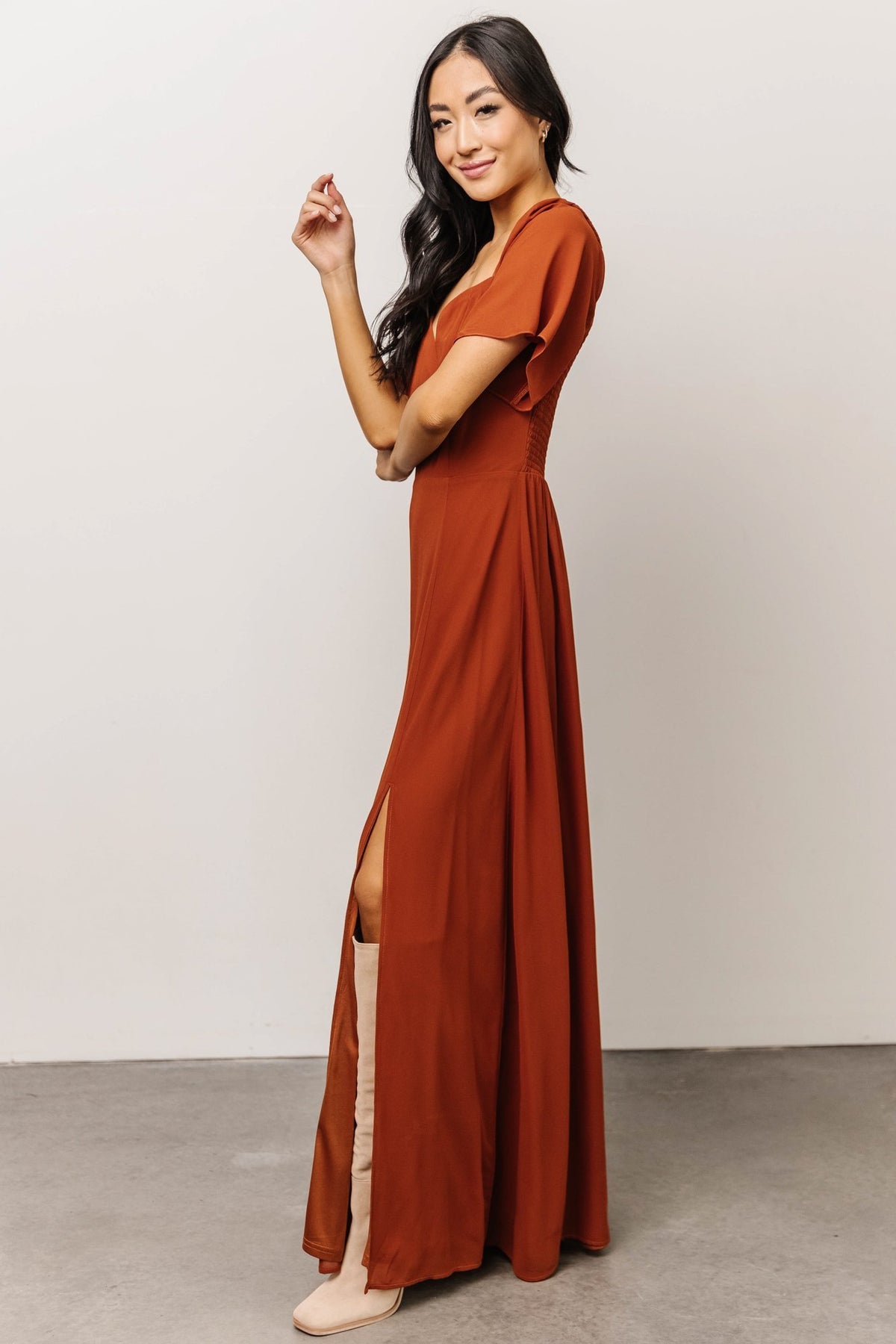Back view of Spice chiffon maxi dress emphasizing smocked back bodice and elastic shoulder design for flexible fit