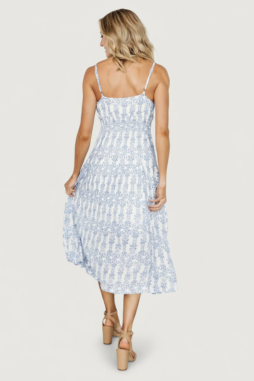 Detail image highlighting the V-neckline, fabric print and the dress's soft texture, showing color contrast between blue and off-white motifs.